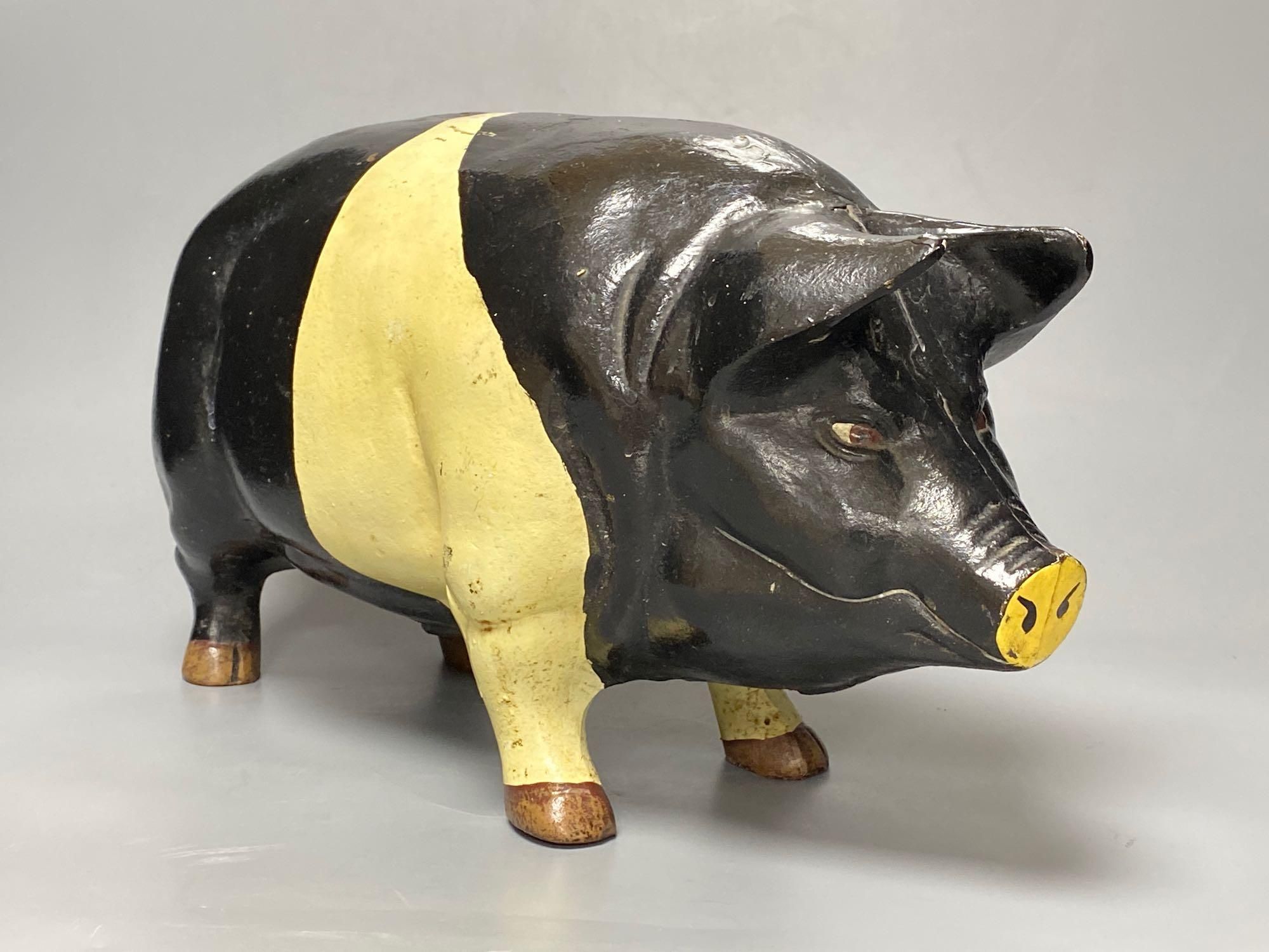 A large heavy cast iron saddle back pig money bank, circa 1950s, length 46cm